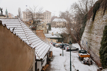Fascinating narrow picturesque street with baroque and renaissance historical buildings, snow in winter day, Novy svet, New World in vicinity of Hradcany, Prague, Czech Republic