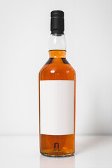 Wiskey bottle branding photo. Mock up glass bottle full with bourbon alcohol. Studio shot. Empty...