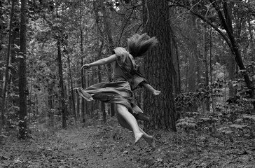 Jumping woman in the forrest