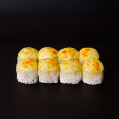 Tempura roll with a cap on a black background