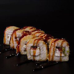Unagi kani roll rolls on black background