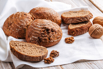 Closeup on rye walnut bread on the wooden decorated table