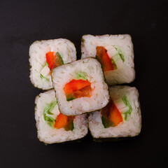 cucumber and salmon rolls on a black background