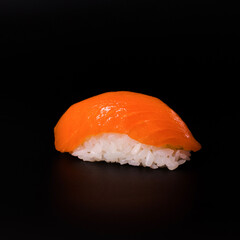 sushi with salmon on a black background