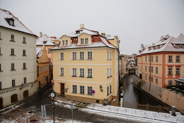 Kampa Island under Charles Bridge and small river Devil, water channel Certovka, Prague Venice under snow in winter day, Mala Strana or Lesser Town district, Prague, Czech Republic