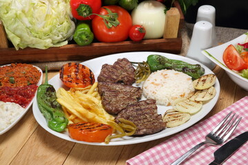 grilled beef steak with grilled tomatoes, pepper, and potatoes fries 