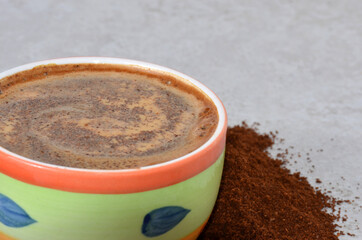 Cup with hot coffee close-up.