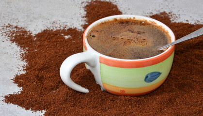 A cup of coffee on the table in the middle of the coffee.