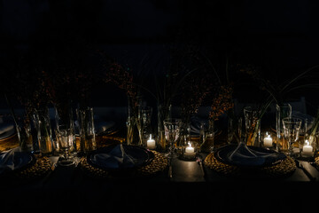 burning candles in the dark on a reserved table for the holiday