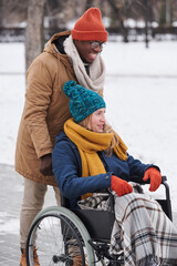 Happy young couple walking outdoors in winter day