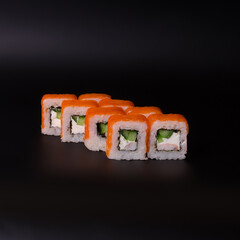 salmon and cheese rolls on a black background
