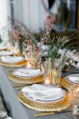decorated with fresh flowers and served table for a festive dinner indoors