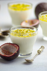 Italian dessert panna cotta with fresh passion fruits on light background. Copy space.