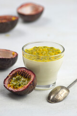 Italian dessert panna cotta with fresh passion fruits on light background. Copy space.