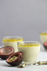 Italian dessert panna cotta with fresh passion fruits on light background. Copy space.