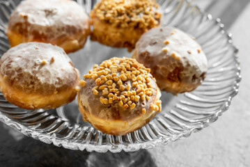  fresh baked donuts with nuts on a epergne (plate)