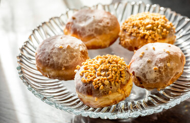  fresh baked donuts with nuts on a epergne (plate)