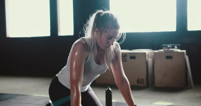 Fitness gear and accessories. Beautiful sporty tired sweaty woman checking smart watch mobile app tracker after workout.
