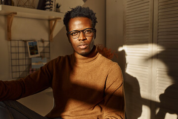 People, home, domestic life and interiors. Handsome fashionable young African male freelancer...