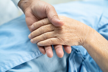 Holding hands Asian senior or elderly old lady woman patient with love, care, encourage and empathy at nursing hospital ward, healthy strong medical concept