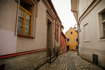 Narrow medieval picturesque street with baroque and renaissance historical buildings in sunny...