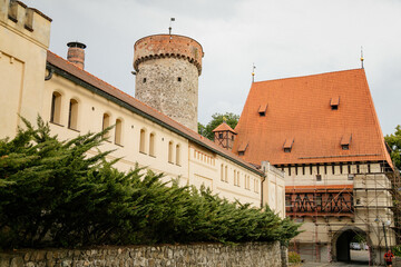 Beautiful historic Tower of Kotnov gothic castle behind town fortification wall on sunny summer day, Bechynska Gate in romantic medieval city Tabor, South Bohemia, Czech Republic