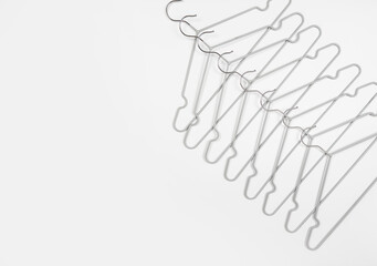 Metal clothes hangers on a light background. Wardrobes were hung for clothes. Place for text