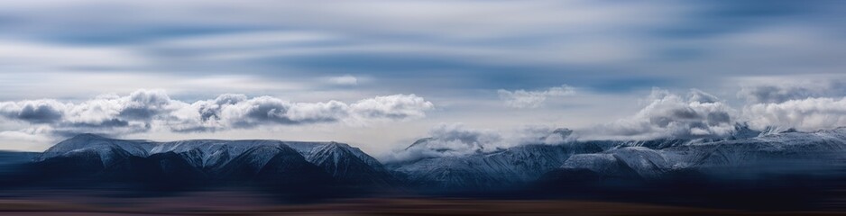Fototapeta premium panoramic view of plain at root of snow-covered mountains on blue sky background