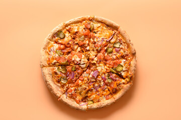 Italian vegan pizza with tomato,cucumber, onion, mozzarella cheese, sauce on beige. Delivery food. View from above.