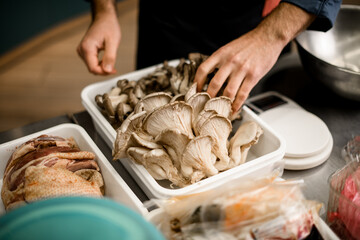Close-up view of fresh oyster mushrooms in white box on kithen.