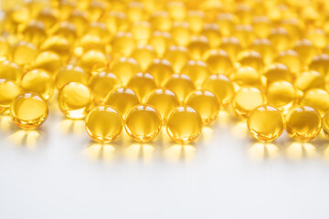 transparent vitamins or gelatin round fish oil capsules, omega-3, food supplement, on a white...