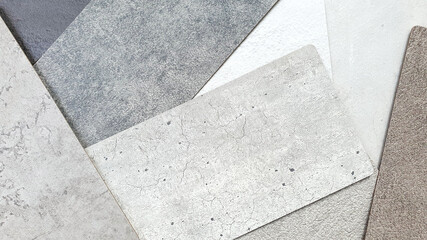 close up detail of concrete laminated samples in grey color tone. interior wall or furniture finishing material samples in various texture and color. abstract rustic loft cement background.