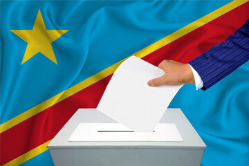 Elections in the country - voting at the ballot box. A man's hand puts his vote into the ballot...