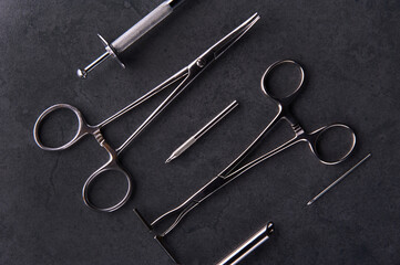 A group of surgical stainless steel body piercing clamps and equipment