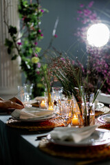 Fototapeta premium Decorator girl serves the table. The process of preparing a linen napkin from a cloth and serving on a plate. View from above. Braided cymbal hoop.