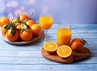 Cup and glass of orange juice on wooden table