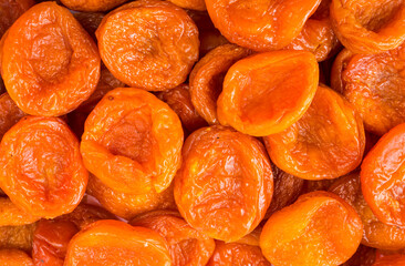 Background of dried apricots. Dried fruits of close up. Top view. Background of dried fruits. Dried apricots from Tajikistan. Dried fruit in the sun.