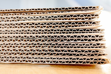 Bundle of brown paperboard packaging stack, ready for shipping. Abstract rough detail pattern and...