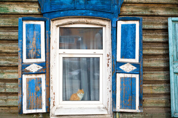Fototapeta na wymiar Closeup view of an old window in a wooden house in Russia