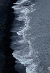 Waves on the black beach. Top view. Air shoot. 