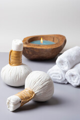 Fototapeta na wymiar Spa composition of a herbal ball massage, towel with a candle