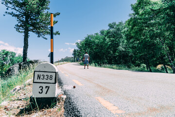 Man in shorts waling on road roadtrip
