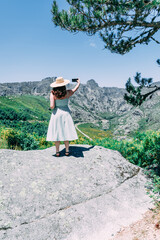 Woman in straw hat overlooking  mountains Serra da Estrela Portugal