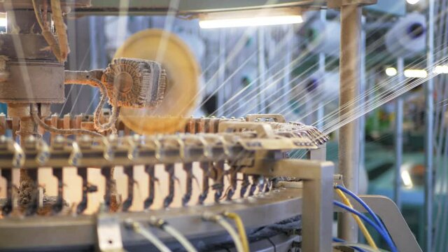 Weaving of fabric on cars. Production of fabric from threads at factory. Textile factory industry. Fabric making machines.