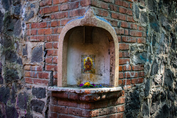 Small altar on the corner of a stone wall