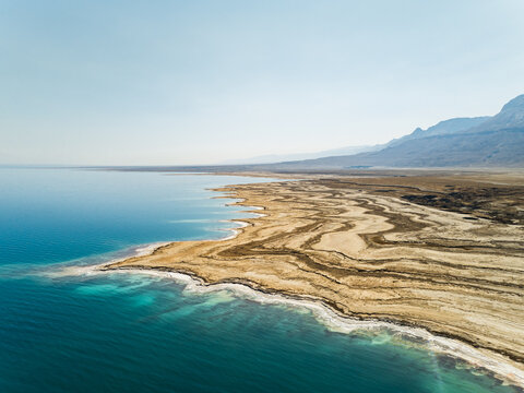 Aerial view of the texturized expanding shoreline in the Dead sea as the water level decreases. Negev, Israel.