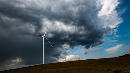 Storm clouds brewing over a wind turbine in Kittitas County in central Washington State as welcome...
