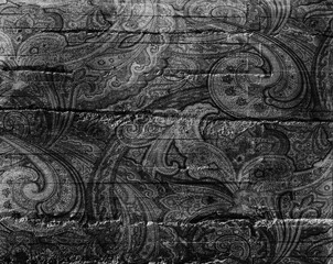 Vintage black and white paisley pattern on textured background