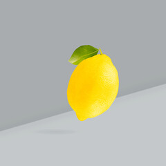 Color of the year Illuminating yellow and Ultimate Gray. Falling down yellow lemons on two-tone background.