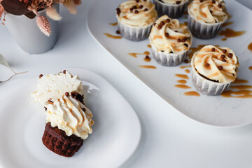 Chocolate cupcake with cream cap cut in half With caramel filling inside
